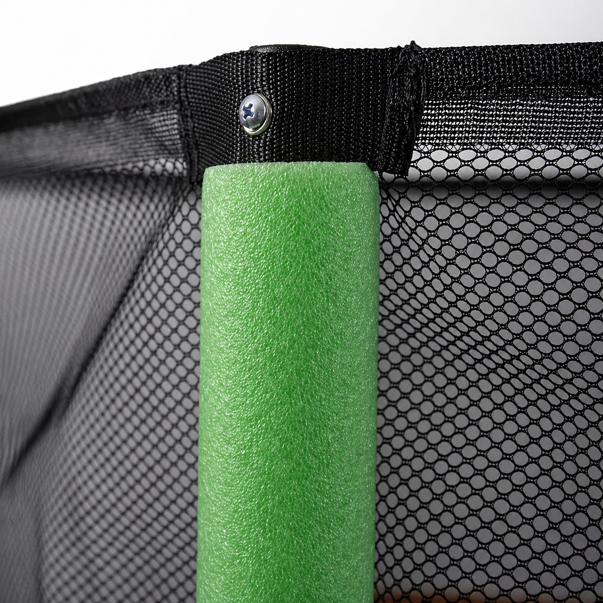 Children's trampoline safety enclosure net with green foam-padded steel pole.