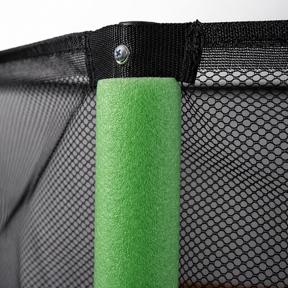 Children's trampoline safety enclosure net with green foam-padded steel pole.